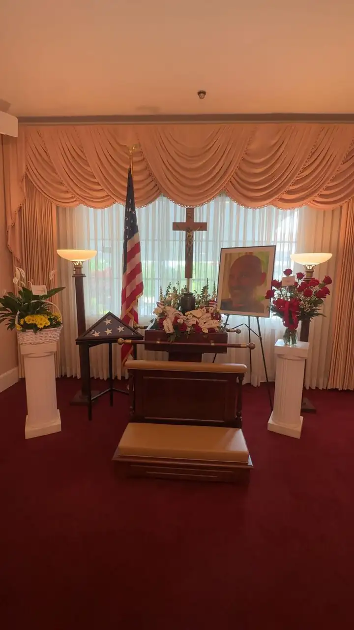 Dad’s memorial service: the American flag, a folded flag case, a cross and his portrait among the flowers