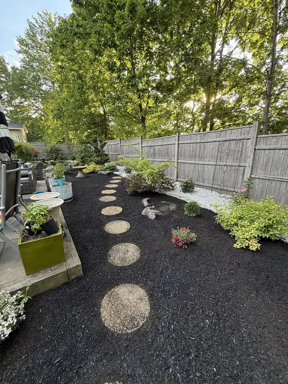 Stepping-stone path through fresh black mulch