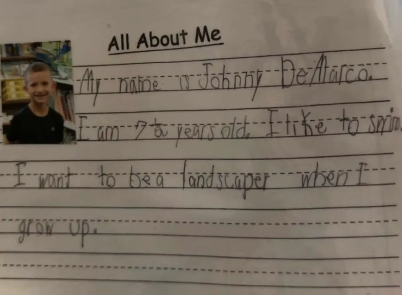 Johnny's handwritten All About Me page from second grade, with his school photo: My name is Johnny DeMarco. I am 7 and a half years old. I like to swim. I want to be a landscaper when I grow up.